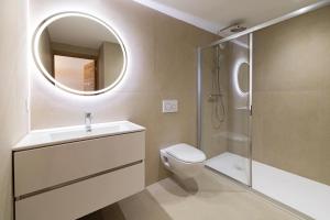 a bathroom with a toilet and a sink and a mirror at Appart'hotel Saint Francois in Calvi