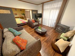a living room with a couch and chairs and a television at NOA - Vacation STAY 80085v in Shikyū