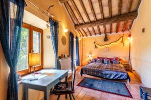 a bedroom with a bed and a desk in a room at Paradis Oasis Santa Maria in Chiusdino +97 photos