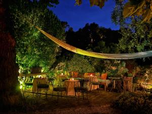 a patio with tables and chairs at night at Les Rosées in Mougins +70 photos