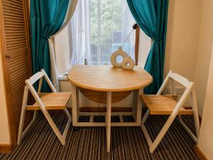 a table and two chairs in a room with a window at 54 - Room 4 - Very spacious in Swansea
