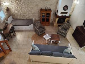 an overhead view of a living room with a couch and chairs at Gîte Maelga in Cartelègue
