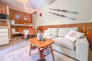 a living room with a couch and a table at L'Argentière - Nature - Calme - Ski in Le Bourg d'oisans +23 photos