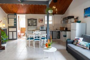a kitchen and living room with a couch and a table at Li-line Diamant in Le Diamant