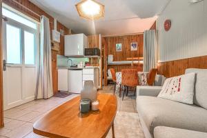a living room with a couch and a table at L'Argentière - Nature - Calme - Ski in Le Bourg d'oisans