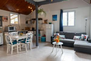 a living room with a couch and a table at Li-line Diamant in Le Diamant +14 photos