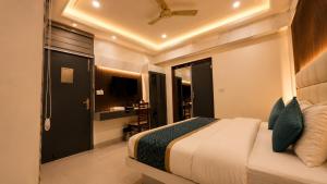 a bedroom with a large bed and a bathroom at Hotel Baba Deluxe near New Delhi Railway Station and City Center -By RCG Hotels in New Delhi +36 photos