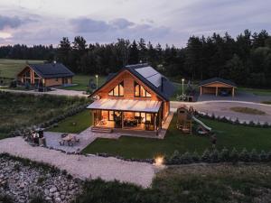 a large wooden house with a playground in a field at Chatka u tatka in Vysoké Tatry