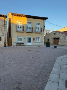a large house with a patio in front of it at El abrazo de La Yecla in Espinosa de Cervera