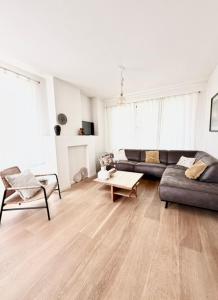 a living room with a couch and a table at De Blinker in Damme