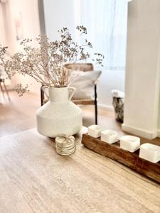 a vase sitting on a table with a group of candles at De Blinker in Damme