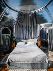 a bedroom with a bed in a large room at Nids des Marais in Ciney