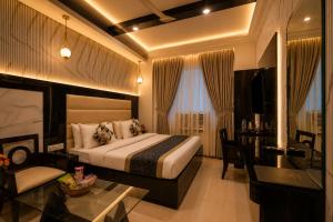 a hotel room with a bed and a desk at Hotel Baba Deluxe near New Delhi Railway Station and City Center -By RCG Hotels in New Delhi