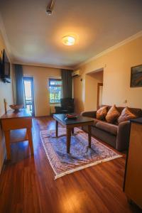 a living room with a couch and a table at Family Resort Hotel in Selimpasa