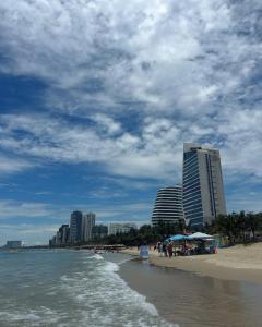 a view of a beach with buildings and the ocean at Mango Home & Apartment in Danang
