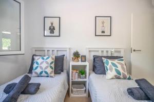 a bedroom with two beds with pillows at Casa Cedro - Modern Golf Resort in Torre-Pacheco +33 photos