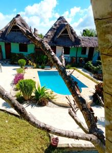 a house with a swimming pool in front of it at Sweet Home in Kiwengwa