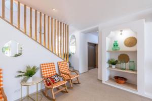 a hallway with two chairs and a staircase at SOL by Meliá Cala d'Or Apartamentos in Cala d´Or