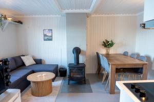 a living room with a couch and a wood stove at Authentic rorbu by the sea in Stamsund +21 photos