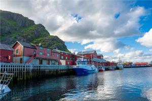 a group of boats are docked in a harbor at Authentic rorbu by the sea in Stamsund