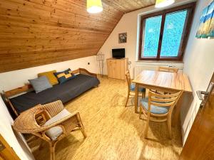 a bedroom with a bed and a table and chairs at Ubytko Ivko in Letohrad
