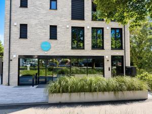 a building with glass doors and plants in front of it at Mikes Apartments Munich in Munich