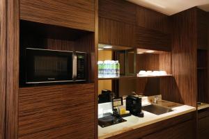 a kitchen with a microwave and a sink in a room at LihPao Resort - Fullon Hotel in Houli