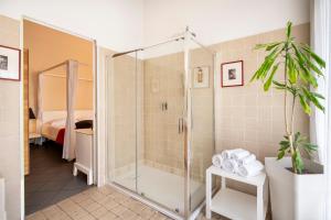 a shower with a glass door in a bathroom at Snob Luxury Suite in Cagliari