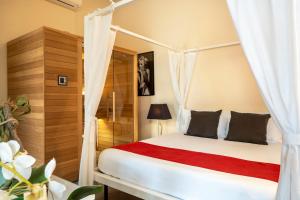 a bedroom with a bed with a canopy at Snob Luxury Suite in Cagliari