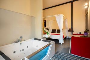 a bathroom with a tub and a bedroom with a bed at Snob Luxury Suite in Cagliari