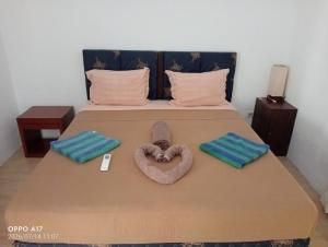 a bed with a heart made out of towels on it at Ani Bungalows in Gili Trawangan