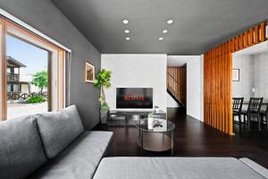 a living room with a couch and a tv at VIOLET GARDEN - Vacation STAY 37201v in Furano