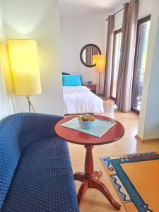 a room with a bed and a table and a couch at Villa Boris- Next to the Beach with Parking in Ohrid