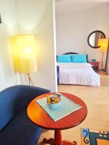 a room with a bed and a table and a bed at Villa Boris- Next to the Beach with Parking in Ohrid