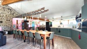 a dining room with a wooden table and chairs at Domaine de Bellac - Le Triangle in Roussines