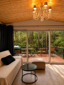 a living room with a couch and a table at Pinecone Luxury Glamping in Louvaras