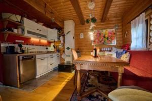 a kitchen with a wooden table in a room at Petite Noel in Güssing
