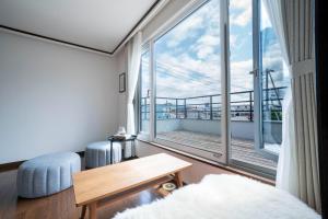 a living room with a large window and a table at SEKKA - Vacation STAY 20179 in Furano