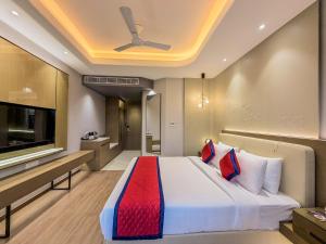 a hotel room with a bed and a television at Jain Tree by Spree Hotels Vellore in Vellore +49 photos