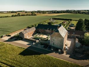 an aerial view of a large building with a field at Domaine Sur Les Sarts in Ohey
