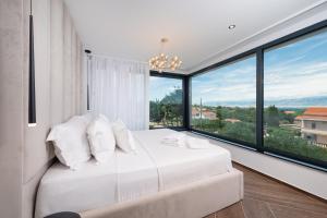 a bedroom with a large white bed and large windows at Villa Perla Vir in Vir +58 photos