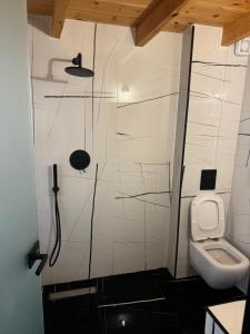 a bathroom with a toilet and a sink at 44 suites Lygia in Paralia Vrachou