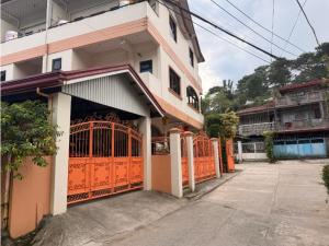 a building with an orange gate in front of it at Balancia Guest House 3F unit 5 in Baguio