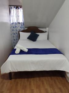 a bedroom with a bed with two towels on it at Balancia Guest House 3F unit 5 in Baguio
