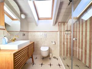 a bathroom with a sink toilet and a shower at La Casa de las Flores in Noceda del Bierzo +42 photos