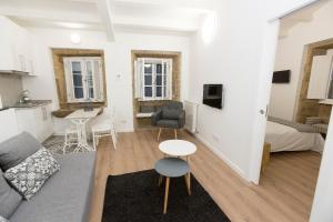 a living room with a couch and a table at Apartamentos Pombal in Santiago de Compostela