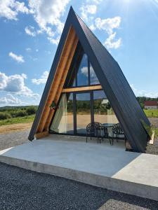 a triangular building with a table and chairs at Jugoslavija Chalet and Spa Zabljak in Tepačko Polje
