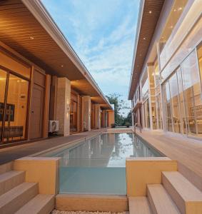 a swimming pool in the middle of a building at KHAMI HOUSE Resort in Panglao Island