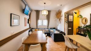 a living room with a table and a couch at Kite & Surf Nomad House in Las Palmas de Gran Canaria