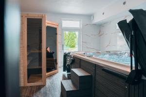 a bathroom with a large tub and a sink at Hotel Mauricius in Příbram